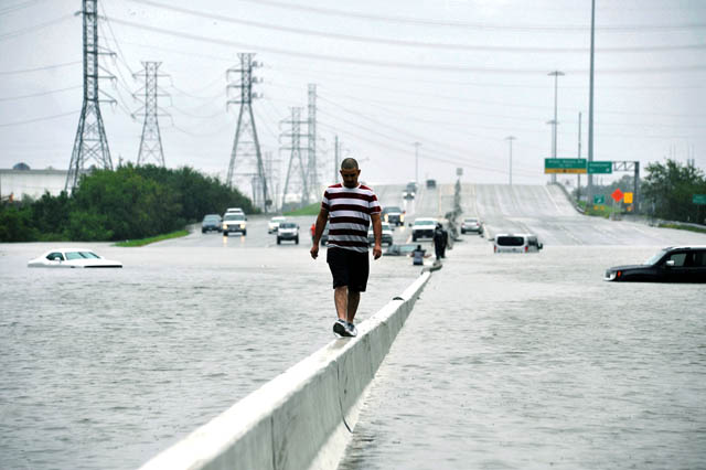 A stranded motorist escapes floodwaters on Interstate 225 after Hurricane Harvey inundated the Texas Gulf coast with rain causing mass flooding in Houston, Texas, US, on Sunday (Reuters photo)